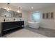 Modern bathroom featuring a double vanity, soaking tub, and stylish fixtures at 1218 Crestwood Se Dr, Atlanta, GA 30316