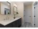 Bathroom featuring a double vanity, neutral walls, modern light fixtures, and a gray tile floor at 1218 Crestwood Se Dr, Atlanta, GA 30316