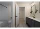 Bathroom featuring a double vanity and neutral walls, leading into bedroom with neutral carpet at 1218 Crestwood Se Dr, Atlanta, GA 30316