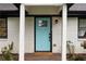Close-up of the entryway featuring a light blue front door and 'Welcome' mat at 1218 Crestwood Se Dr, Atlanta, GA 30316
