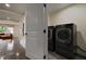 Laundry room with black front load washer and dryer at 1218 Crestwood Se Dr, Atlanta, GA 30316