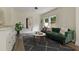Stylish living room with hardwood floors, a green couch, and a view into bathroom at 1218 Crestwood Se Dr, Atlanta, GA 30316