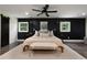 Comfortable main bedroom featuring a dark accent wall, ceiling fan, and natural light at 1218 Crestwood Se Dr, Atlanta, GA 30316