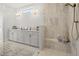 Bright bathroom featuring a double sink vanity, and a large tile shower with built-in bench at 309 Brooke View Trail, Canton, GA 30115