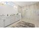 Bright bathroom featuring a double sink vanity, and a large tile shower with glass surround at 309 Brooke View Trail, Canton, GA 30115