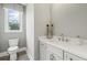Charming bathroom featuring a stylish sink, vanity, and a bright window for natural light at 309 Brooke View Trail, Canton, GA 30115