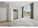 Bright bedroom with a large window, closet, and gray patterned bedding at 309 Brooke View Trail, Canton, GA 30115