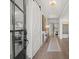 Bright foyer with hardwood floors, white sliding barn door, and decorative table at 309 Brooke View Trail, Canton, GA 30115