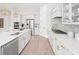 Bright and airy kitchen featuring an island with a sink, white cabinetry, and modern stainless steel appliances at 309 Brooke View Trail, Canton, GA 30115