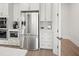 Bright kitchen with stainless steel refrigerator, wall oven, and stylish white cabinets at 309 Brooke View Trail, Canton, GA 30115