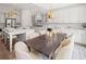 Spacious open-concept kitchen with stainless appliances, white cabinets, an island, and an adjacent dining area at 309 Brooke View Trail, Canton, GA 30115