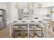 Bright kitchen featuring a large island with seating, modern appliances, and stylish gold pendant lighting at 309 Brooke View Trail, Canton, GA 30115