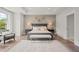 Stylish bedroom featuring a gray color scheme, large window, tray ceiling, and hardwood floors at 309 Brooke View Trail, Canton, GA 30115