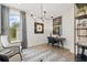 Office space featuring modern décor, light hardwood floors, and a large window at 309 Brooke View Trail, Canton, GA 30115