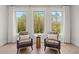 A bright sitting area with two chairs facing a window and hardwood floors at 309 Brooke View Trail, Canton, GA 30115
