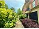 Exterior view of an apartment building with manicured landscaping and private balconies at 560 Dutch Valley Road # 2412, Atlanta, GA 30324