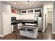Modern kitchen with white cabinets, stainless steel appliances, black countertops, and a stylish island at 560 Dutch Valley Road # 2412, Atlanta, GA 30324