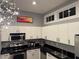 Contemporary kitchen featuring sleek white cabinetry, stainless steel appliances, and modern pendant lighting at 560 Dutch Valley Road # 2412, Atlanta, GA 30324