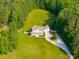 Aerial view of the beautiful house surrounded by lush greenery at 692 Brooks Woolsey Rd, Brooks, GA 30205