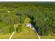 Expansive aerial view of a lovely home surrounded by lush greenery and a long private driveway at 692 Brooks Woolsey Rd, Brooks, GA 30205