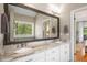 Elegant bathroom features double sinks and a granite countertop, enhancing the home's luxury at 692 Brooks Woolsey Rd, Brooks, GA 30205