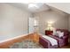 Cozy bedroom with wood floors, neutral paint, and a reading chair set up to enjoy some quiet time at 692 Brooks Woolsey Rd, Brooks, GA 30205