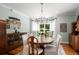 Elegant dining room features hardwood floors, wainscoting, large windows, and a modern chandelier at 692 Brooks Woolsey Rd, Brooks, GA 30205