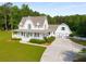 Beautiful country home with a welcoming wrap-around porch and a detached garage, surrounded by mature trees at 692 Brooks Woolsey Rd, Brooks, GA 30205