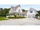 Beautiful two-story farmhouse style home with a wrap-around porch and a large driveway at 692 Brooks Woolsey Rd, Brooks, GA 30205