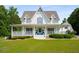 Charming two-story traditional home with a large covered front porch, perfect for relaxing outdoors at 692 Brooks Woolsey Rd, Brooks, GA 30205
