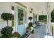 Welcoming front porch featuring a blue door, stylish decor, and comfortable seating overlooking the yard at 692 Brooks Woolsey Rd, Brooks, GA 30205