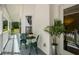 Cozy porch with green chairs and a table, complemented by lush greenery and a view of the yard at 692 Brooks Woolsey Rd, Brooks, GA 30205