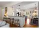 Open-concept kitchen with granite countertops, stainless steel appliances, and a breakfast bar at 692 Brooks Woolsey Rd, Brooks, GA 30205