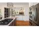 Gourmet kitchen with island, stainless steel appliances and decorative lighting at 692 Brooks Woolsey Rd, Brooks, GA 30205
