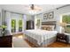 Tranquil main bedroom with wood flooring and a balcony, filled with natural light at 692 Brooks Woolsey Rd, Brooks, GA 30205