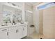 Bathroom showcasing a double vanity, a glass shower with bench, and neutral tile surround at 782 Brooke View Drive, Canton, GA 30115