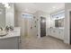 Bright bathroom with double vanity, seamless glass shower, tile surround, and herringbone floor at 782 Brooke View Drive, Canton, GA 30115
