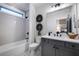 Bathroom featuring a single vanity, combination tub and shower, and patterned tile floor at 782 Brooke View Drive, Canton, GA 30115