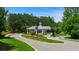 Gated community entrance with meticulously maintained landscaping, mature trees, and classic gatehouse design at 782 Brooke View Drive, Canton, GA 30115