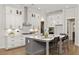 Open kitchen with a large island, white cabinetry, stainless steel appliances, and hardwood floors at 782 Brooke View Drive, Canton, GA 30115