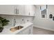 Well-appointed laundry room with sleek white cabinets, modern sink, and bright natural light at 782 Brooke View Drive, Canton, GA 30115