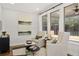 Comfortable living room with large windows providing natural light and scenic views, complemented by cozy seating and elegant decor at 782 Brooke View Drive, Canton, GA 30115