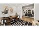Bright office featuring a wood desk, modern art, and an adjacent dining area, creating a versatile and stylish workspace at 782 Brooke View Drive, Canton, GA 30115