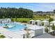 Community pool featuring cabanas, lounge chairs, umbrellas, and beautifully landscaped common areas at 782 Brooke View Drive, Canton, GA 30115