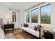 Charming sitting area with large windows offering scenic views, a comfortable daybed, and stylish accents, perfect for relaxation at 782 Brooke View Drive, Canton, GA 30115