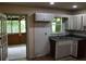 Functional kitchen with ample natural light and a seamless transition to the screened-in porch at 8469 Shiloh Ct, Jonesboro, GA 30238