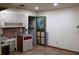 Functional kitchen with bright cabinetry, a backsplash, and newer flooring at 8469 Shiloh Ct, Jonesboro, GA 30238