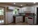 Well-lit kitchen with traditional cabinetry, a window, and a convenient layout at 8469 Shiloh Ct, Jonesboro, GA 30238