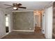 Bright living area with textured walls, a ceiling fan, and multiple entryways at 8469 Shiloh Ct, Jonesboro, GA 30238