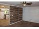 Inviting living area with wood accent wall, a ceiling fan, and seamless transition to kitchen at 8469 Shiloh Ct, Jonesboro, GA 30238
